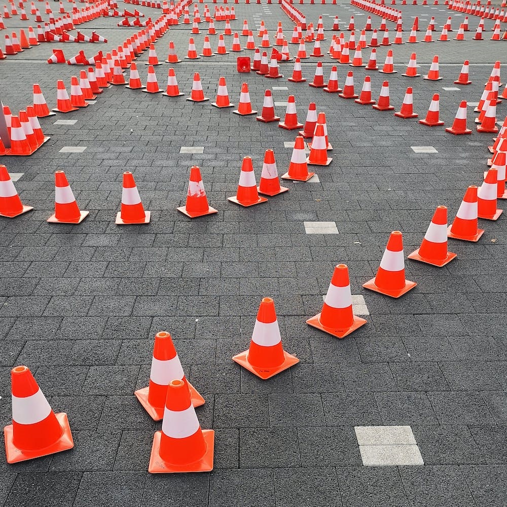 image of various seemingly-random trails of orange traffic cones.